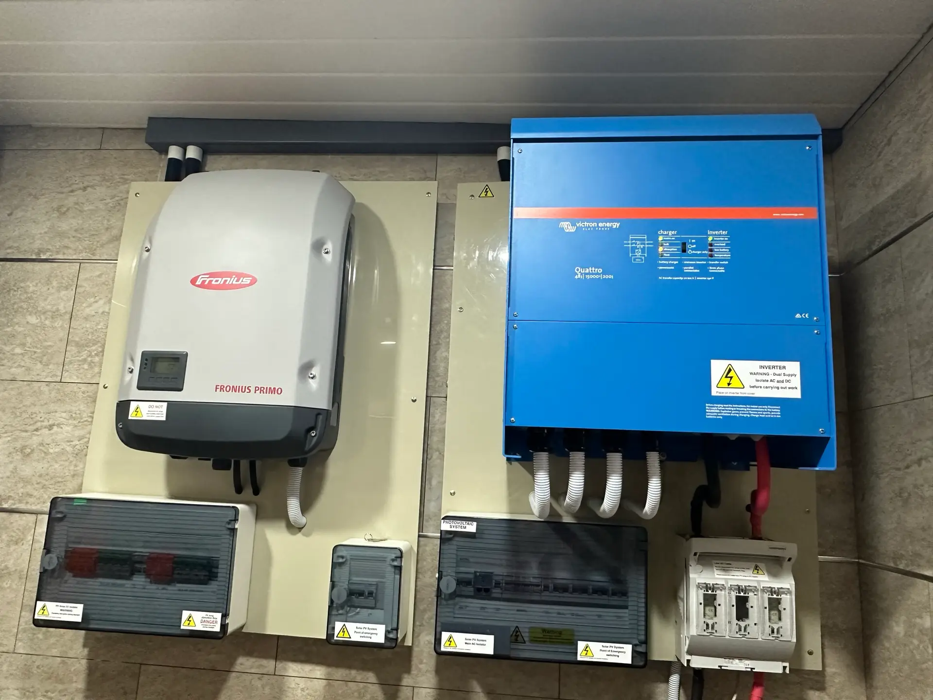 A Fronius inverter beside a Victron Quattro