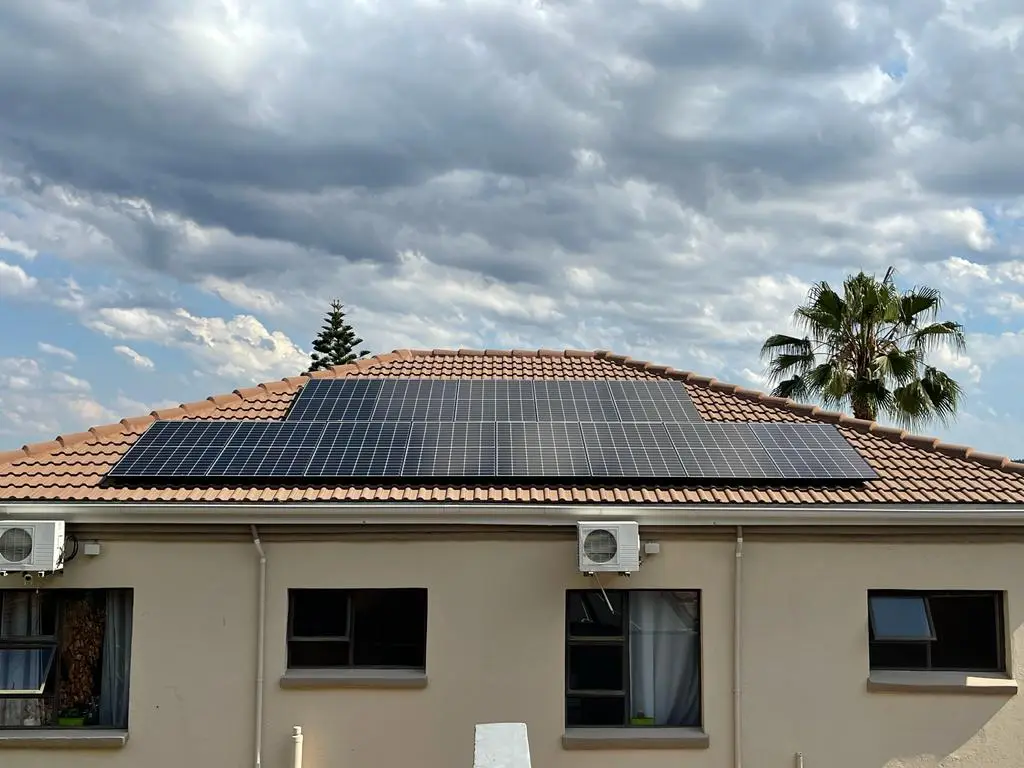 Panels on a house roof under a blue sky