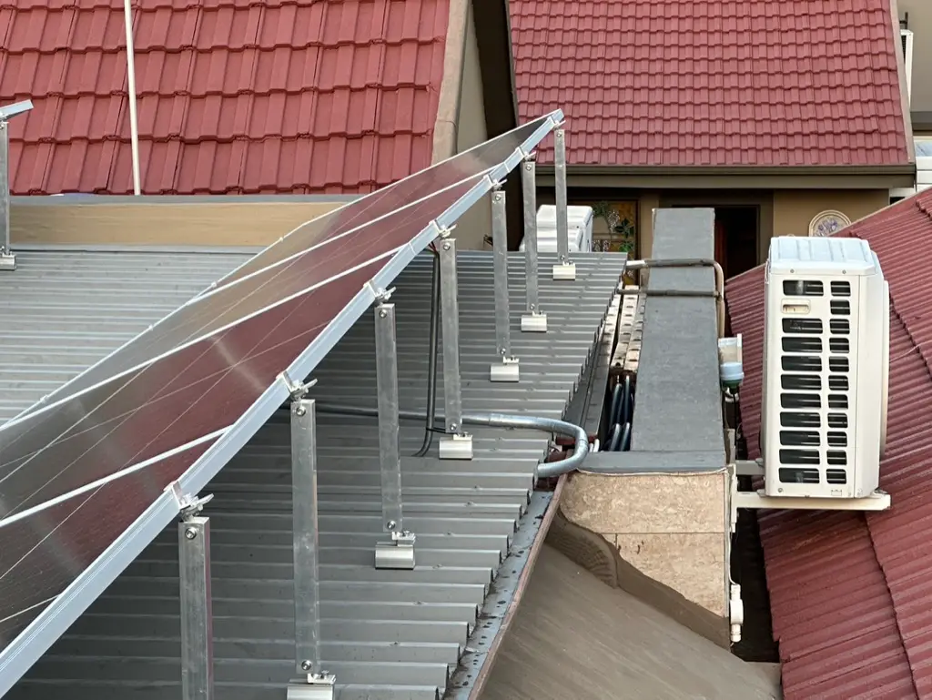 Mounting rails going up beside an air conditioner